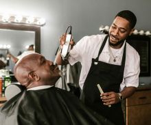 A Barber Trimming a Man's Beard